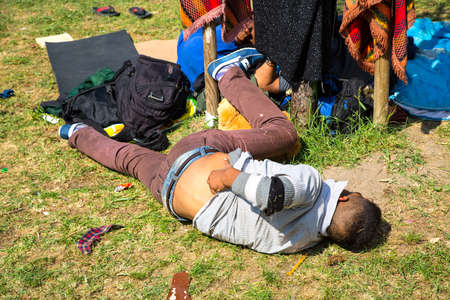 BUDAPEST, HUNGARY - SEPTEMBER 04: Exhausted Refugee in front of the eastern Train Station Keleti Palyudvar on September 04, 2015 in Budapest, Hungary.のeditorial素材