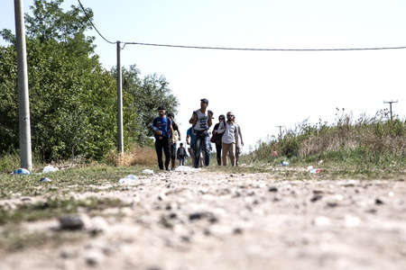 TOVARNIK, CROATIA - SEPTEMBER 19: Refugees walk across the border from Serbia to Croatia on September 19, 2015 in Tovarnik, Croatia.のeditorial素材