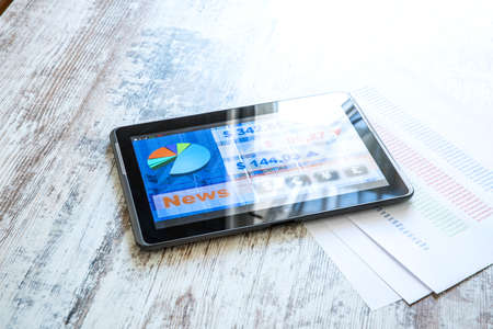 Stock market trading and research software on a Tablet PC on a office Desktop.