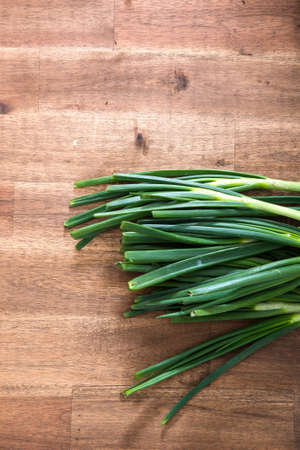 Organic leek on a wooden kitchen Table.の写真素材