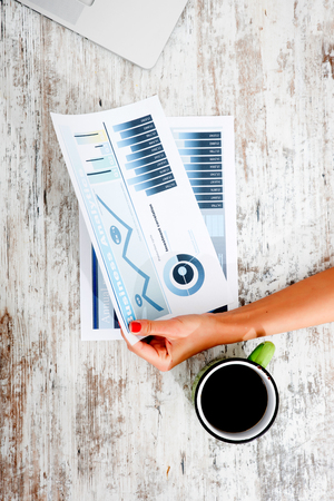 A young woman holding a analytical spreadsheet for her business.の写真素材