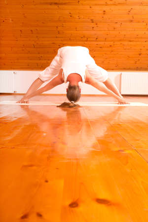 A young Woman practicing Yoga in a attic Studio.の写真素材