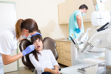 A young girl getting her dental checkup at the dentist.の写真素材