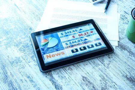 Stock market trading and research software on a Tablet PC on a office Desktop.の写真素材