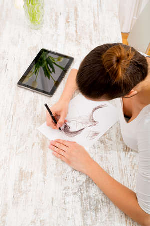 A young fashion designer working with a tablet pc.&#xA;の写真素材