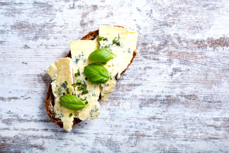 European style sandwiches with Roquefort cheese and Basil leaves on dark bread.
の写真素材