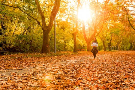 Beautiful young woman having a walk in the Forest in the autumn.の写真素材