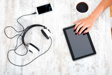 Beautiful young woman using a tablet pc at homeの写真素材