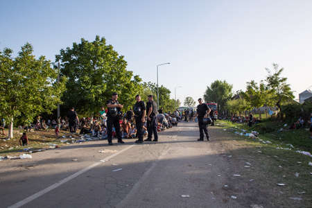 TOVARNIK, CROATIA - SEPTEMBER 18: Police guards the waiting line of Refugees on September 18, 2015...
