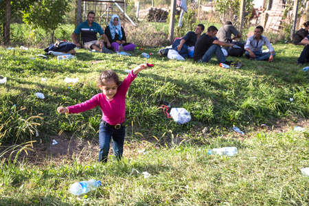 TOVARNIK, CROATIA - SEPTEMBER 18: A refugee child plays among trash on September 18, 2015 in Tovarnik, Croatia.のeditorial素材