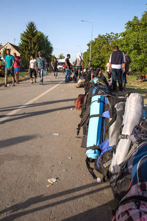 TOVARNIK, CROATIA - SEPTEMBER 18: Stranded Refugees form a waiting line in order to get a transported further towards northern Europe on September 18, 2015 in Tovarnik, Croatia.のeditorial素材