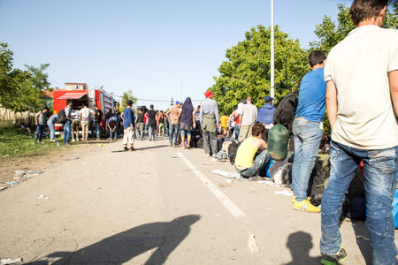 TOVARNIK, CROATIA - SEPTEMBER 18: Stranded Refugees form a waiting line in order to get a...