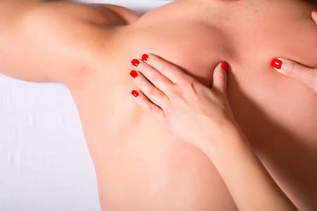 A young muscular built man receiving a massage on his back.の写真素材