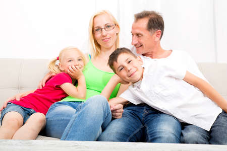 Happy family sitting together on the couch
