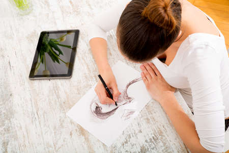 A young fashion designer working with a tablet pc.の写真素材