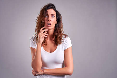 A beautiful young woman looking surprised