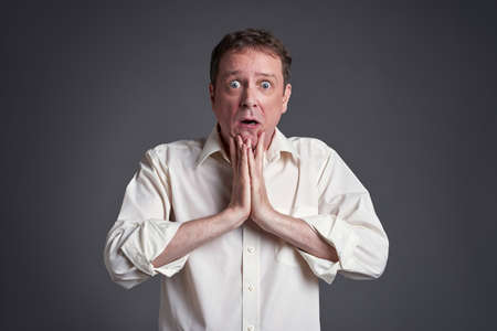 Middle age man feeling frightenedの写真素材