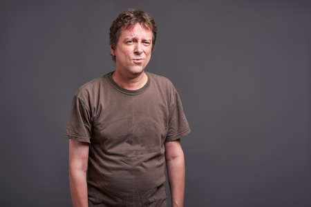 Expressions of a middle age man feeling boredの写真素材