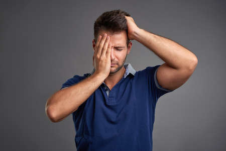 A handsome young man feeling sad and desperate