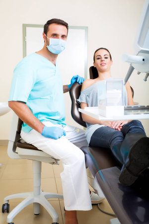 A young woman at her Dentists appointment.の写真素材