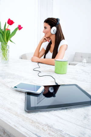 Portrait of a young beautiful woman listening to music with headphonesの写真素材