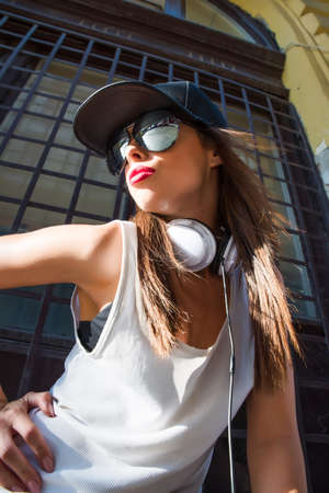 A beautiful young Hip Hop Rapper girl with Headphones in a urban environment.
の写真素材