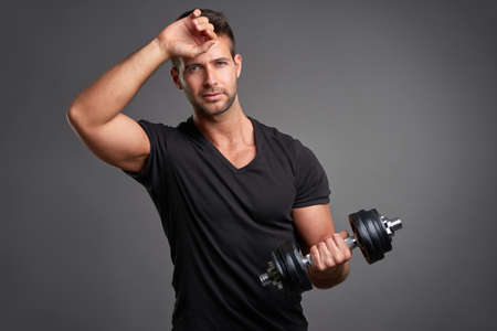 Young man lifting weight