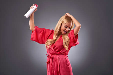 Young woman with a hairsprayの写真素材
