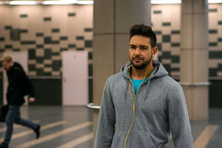 A handsome young sportsman walking in the undergroundの写真素材