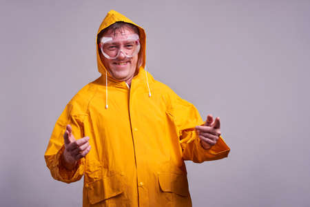 Man in yellow raincoatの写真素材