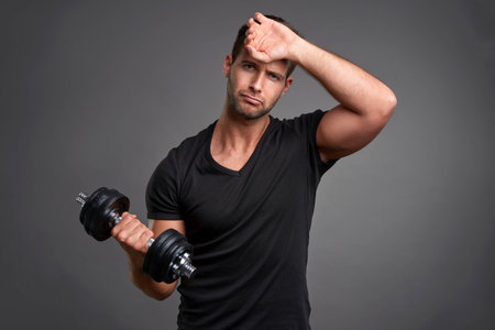 Young man lifting weightの写真素材