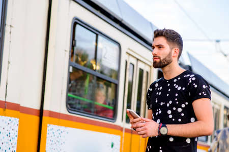 Young hipster man in a tram stationの写真素材