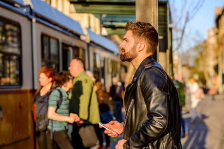 Young man waiting in a tram station