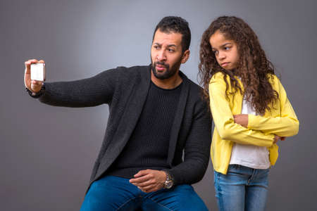 Black father taking selfie with his daughterの写真素材