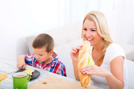 A mother and her children having breakfast at home.