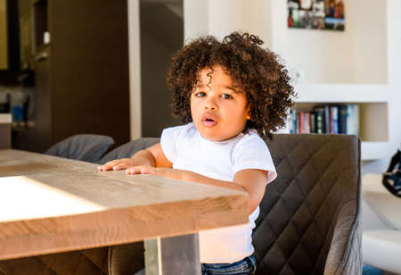 Afro child sitting at the tableの写真素材