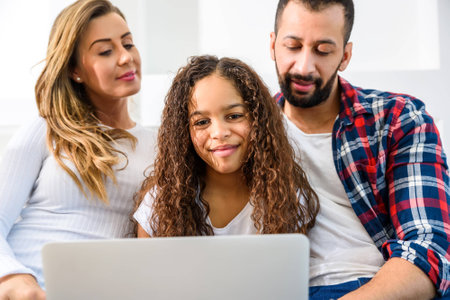 Young family sitting on the couchの写真素材