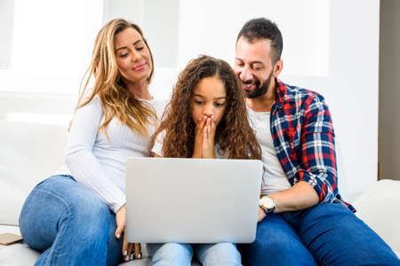 Young family sitting on the couch