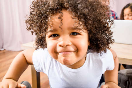 Afro child sitting at the tableの写真素材