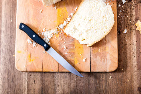 Cutting bread on a wooden Tableの写真素材