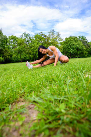 Beautiful young sporty girl in a parkの写真素材