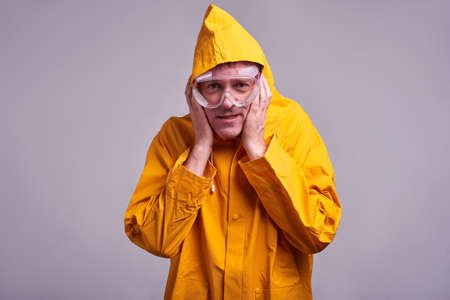Man in yellow raincoatの写真素材