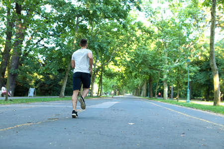 A handsome young man jogging in a parkの写真素材