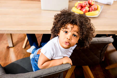 Afro child sitting at the tableの写真素材