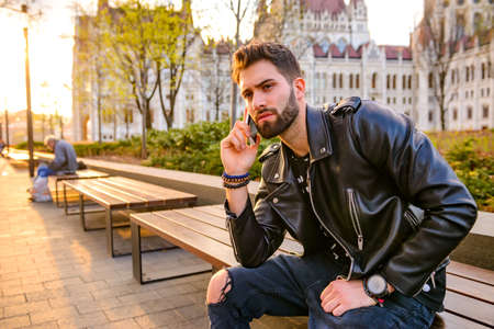 Young man sitting on a benchの写真素材