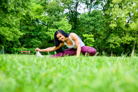 Beautiful young sporty girl in a park
