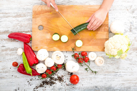 A womans hand with vegetables
