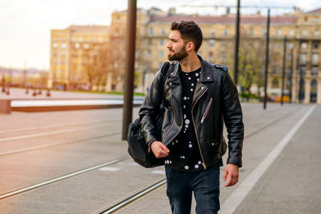 Young man next to the tramlineの写真素材