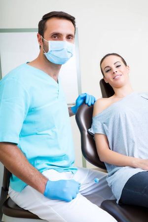 A young woman at her Dentists appointment.の写真素材