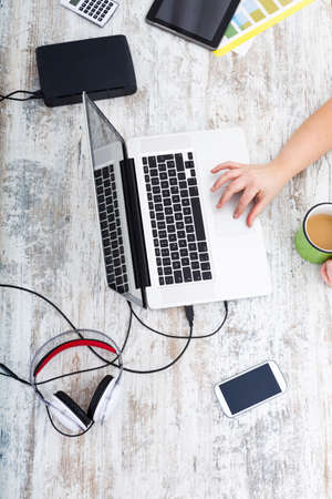 A plus size adult woman working in the home office.